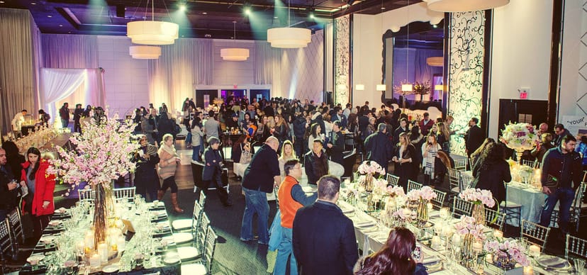 Elegant Grand Luxe banquet hall with floral centerpieces for formal gala and corporate events.