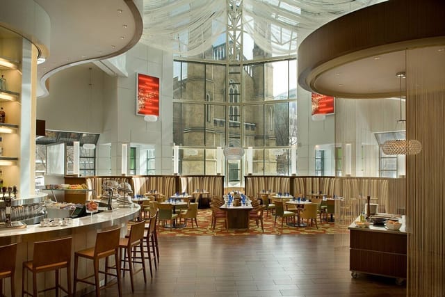 Modern ballroom with glass atrium for upscale corporate receptions and networking events.