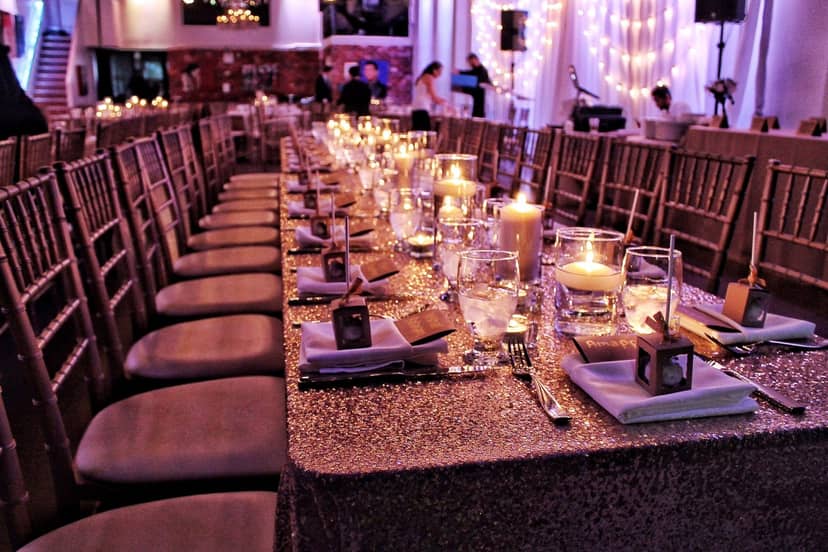 Glam gala event setup at The Factory Lounge with sequin linens and candles for formal banquets.