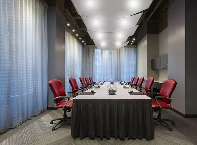Pantages Hotel boardroom with red seating for executive meetings and corporate events.