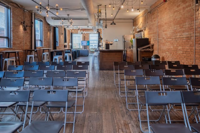 Industrial-chic StartWell breakout room set for theater-style corporate workshop or event.
