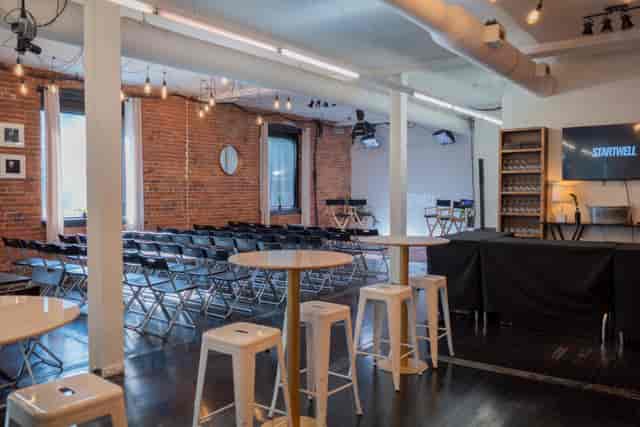 Cube at StartWell: Industrial-chic seminar venue with theater seating for corporate events.
