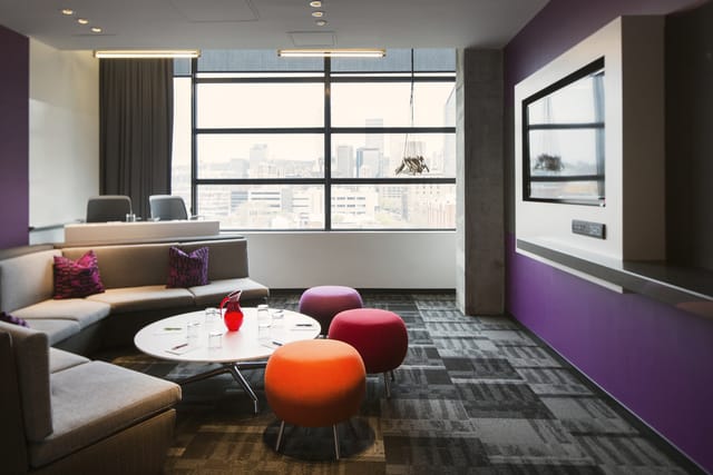 Rose-Fuchsia lounge at Alt Hotel Toronto: modern breakout space for informal corporate meetings.