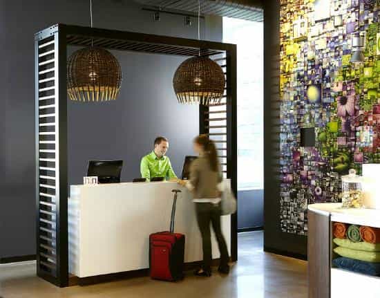 Modern purple reception desk at Alt Hotel Toronto Airport for efficient event delegate check-in.