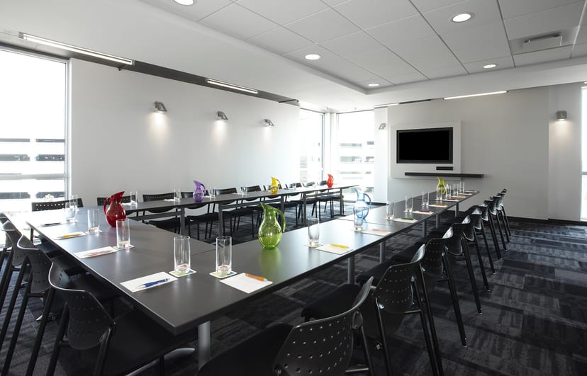 Modern U-shaped boardroom at Alt Hotel Toronto Airport for professional workshops and meetings.