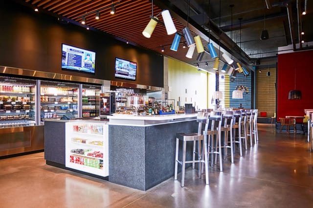 Alt Hotel Toronto networking mixer with high-top seating and AV branding for corporate events.