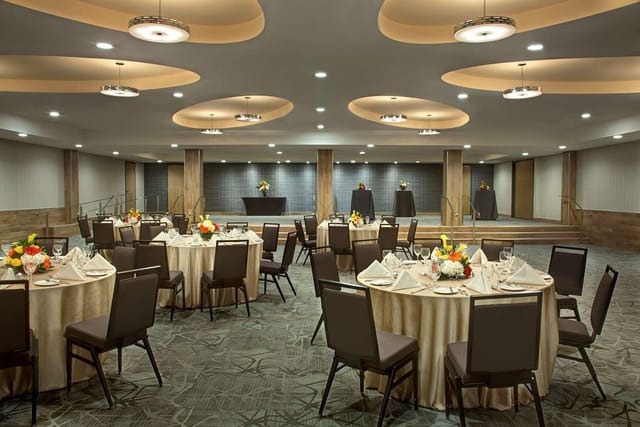 Ballroom event space with raised stage for corporate gala or banquet at Hilton Toronto Airport.