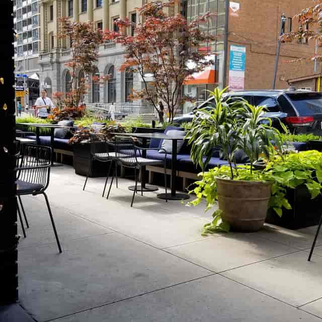 Scarlet Door Cafe: Intimate al fresco networking reception with lounge seating and urban backdrop.
