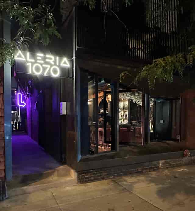 Upscale Aleria restaurant interior with moody lighting for evening reception and gala events.