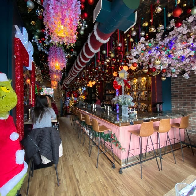 Holiday-themed bar at Aleria with dense festive decor for corporate mixers and event catering.