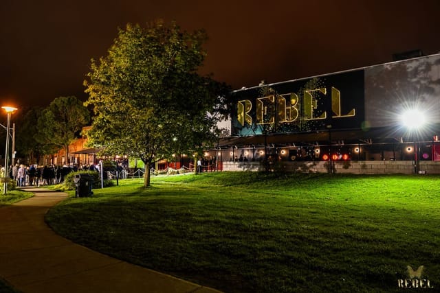 Bar in Rebel (INK) venue exterior with queue stanchions for high-energy nightlife events.