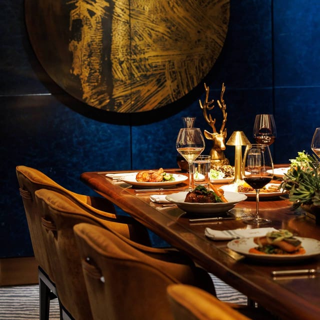 Intimate private dining room with moody lighting for executive dinners and VIP client events.