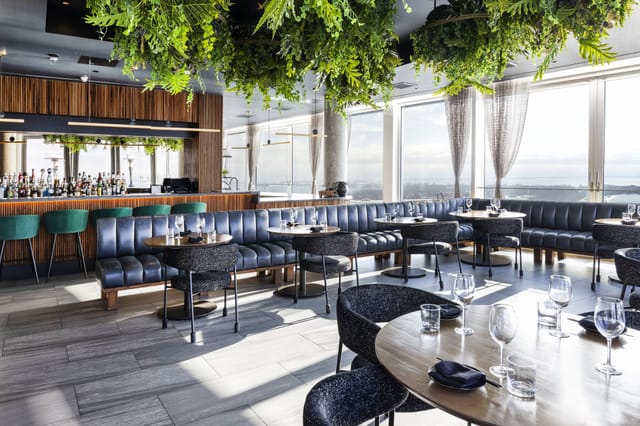 High-end rooftop restaurant with biophilic design for corporate mixers and VIP events.