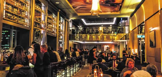 LOUIX LOUIS multi-level lounge featuring elegant bar seating for corporate and networking events.
