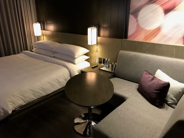 Modern Rouge Room hotel guest room with dedicated workspace for business travel and events.