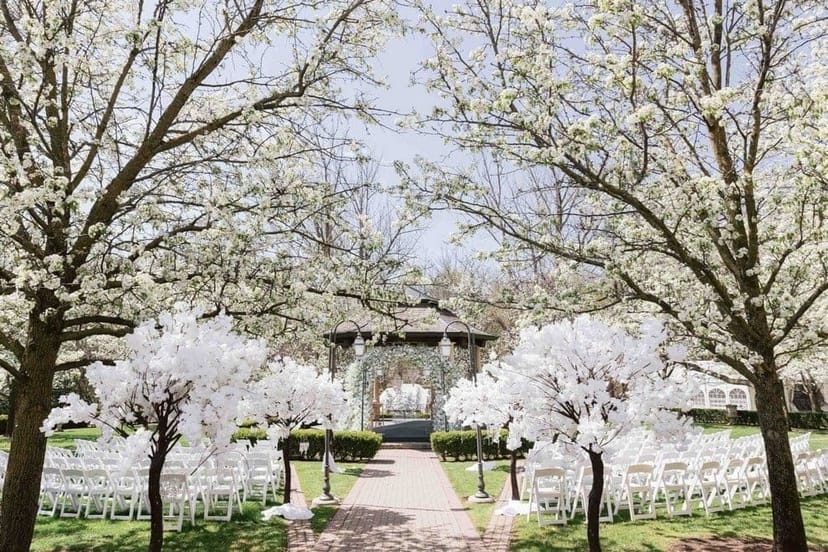 Outdoor wedding ceremony at Village at Black Creek featuring a romantic gazebo and floral accents.