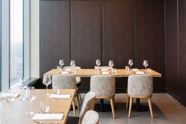 Sleek private dining room with window views for executive dinners and corporate events.