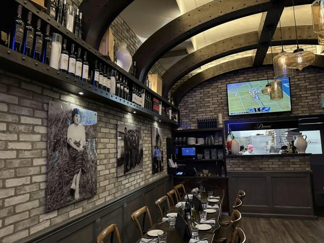 Private dining at Dimmi Trattoria with rustic brick walls for intimate events and board meetings.