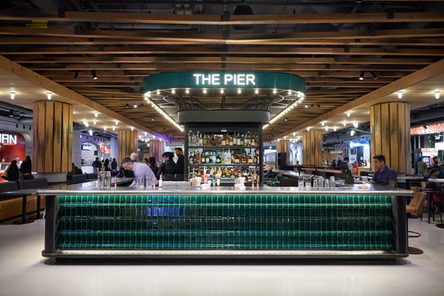 Branded bar at corporate reception, well-lit networking focal point for event activation.