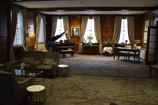 Primrose Room wood-paneled suite for upscale board meetings and VIP receptions.