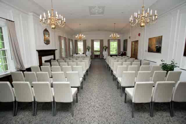 Fairley Lounge theater-style setup with elegant chandeliers for corporate meetings or weddings.