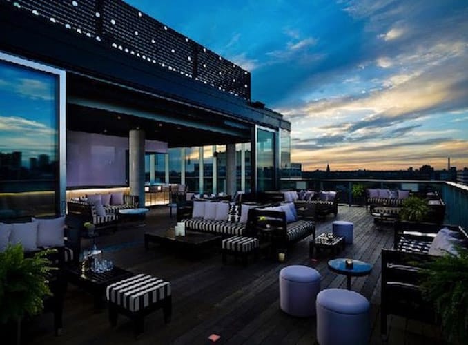 Rooftop terrace lounge set for VIP cocktail hour and networking reception.