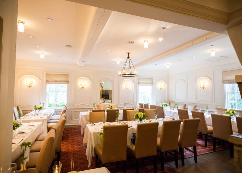Elegant private dining room with banquet seating for corporate boardroom dinners or workshops.