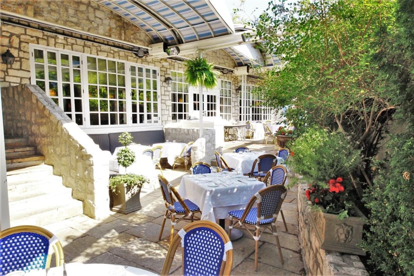 Auberge du Pommier elegant outdoor restaurant patio for intimate wedding luncheon or reception.