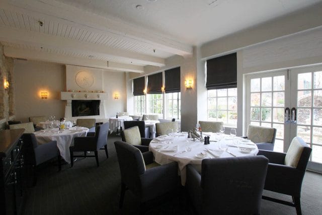 Auberge du Pommier private dining room with fireplace for corporate events and board meetings.
