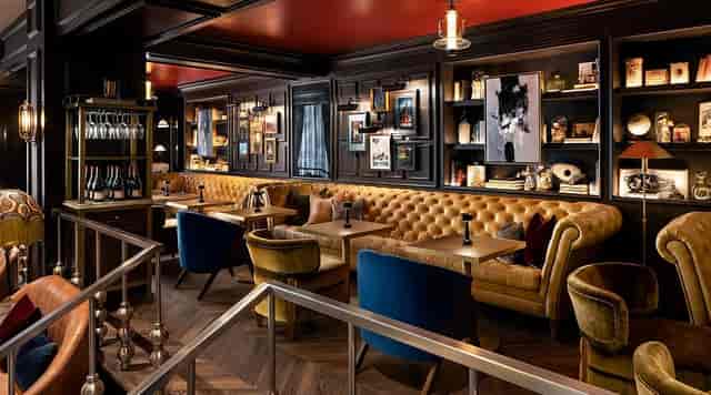 Upscale Library Bar lounge with modular seating for VIP receptions and networking events.