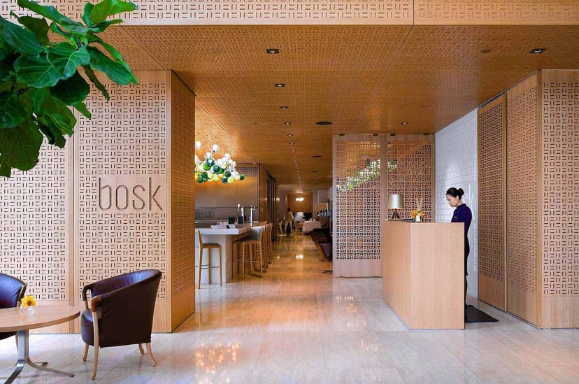 Upscale Bosk restaurant entrance with wood millwork for VIP registration and event hospitality.