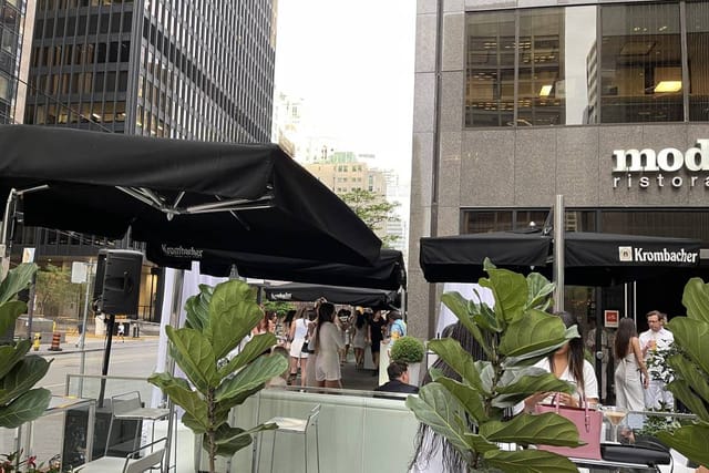 Modus Ristorante patio with branded umbrellas for corporate networking and city event hosting.