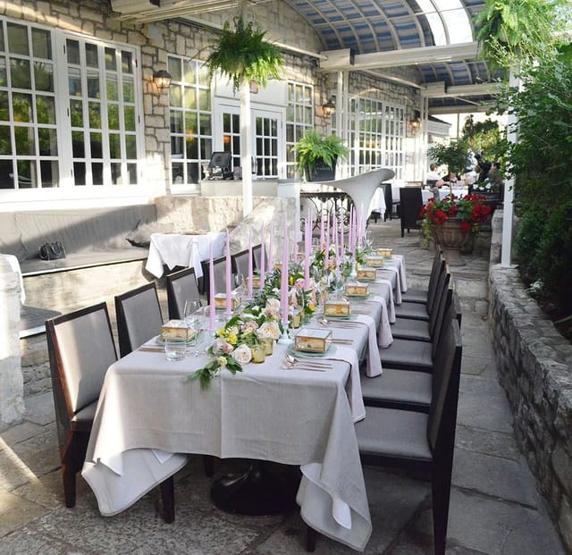 Elegant outdoor banquet setup on stone patio for private dining events and luxury wedding receptions.