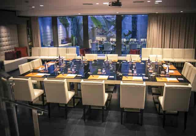 Boardroom setup at Hotel Indigo Barcelona, featuring hollow-square seating for executive meetings.