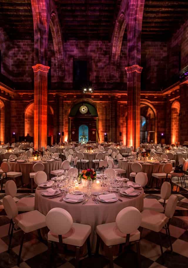 Gala dinner setup at La Llotja de Mar Contracting Hall with dramatic uplighting for corporate events.