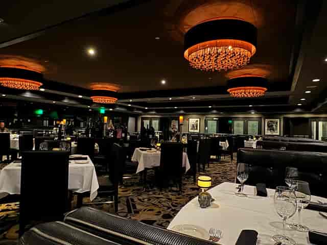 Upscale Morton's steakhouse dining room with mood lighting for corporate dinners and retreats.