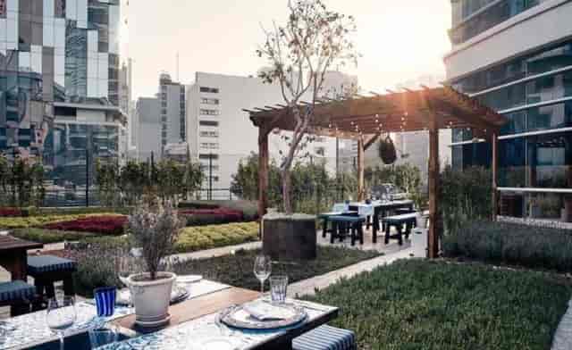 St. Regis secret garden rooftop venue with string lights for corporate events and networking.