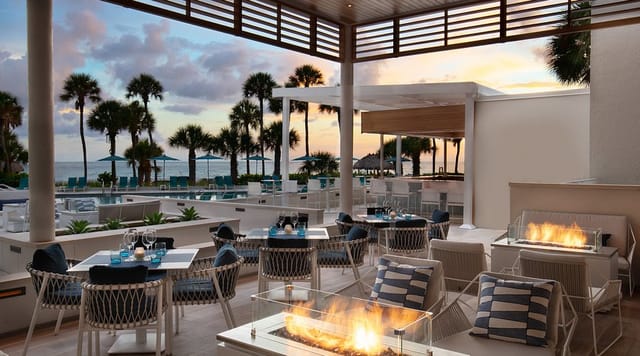 Beachfront sunset reception venue at The Resort at Longboat Key Club with fire pits.