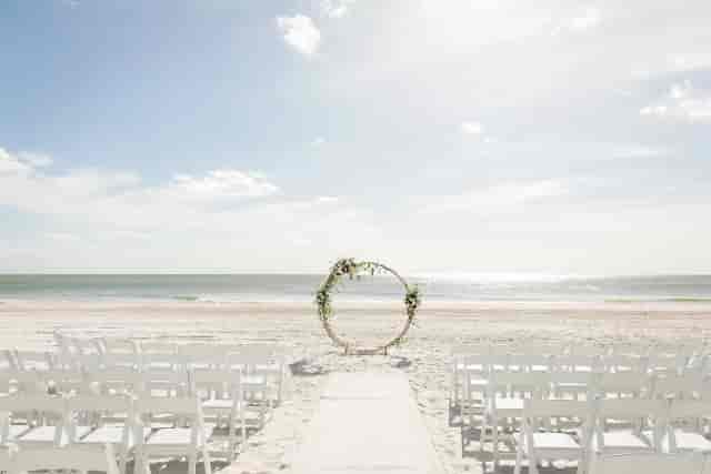 Minimalist floral arch at Lagoon Lawn wedding ceremony, The Resort at Longboat Key Club.