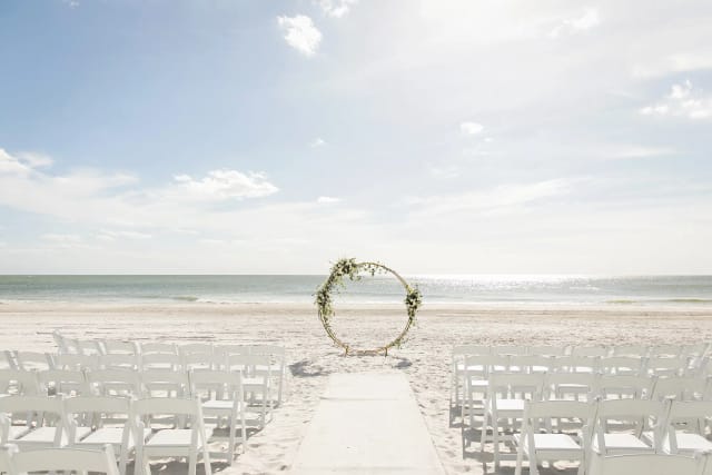 Minimalist floral arch at Lagoon Lawn wedding ceremony, The Resort at Longboat Key Club.