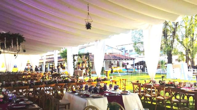 Outdoor banquet hall with elegant draping for weddings and corporate events.