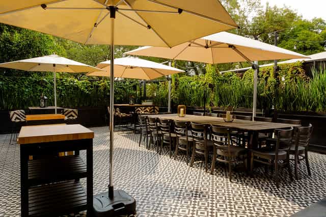Modular lounge seating under umbrellas at Terrace in Brocante for intimate al fresco events.