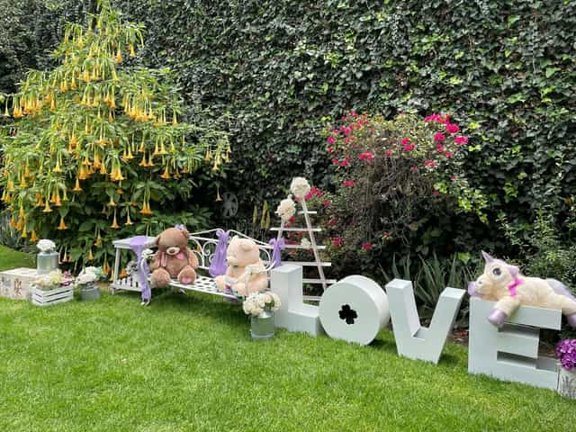 Whimsical outdoor LOVE marquee photo op at Jardín Florencia children's party event activation.