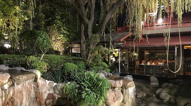 Upscale restaurant with lush landscaping and water features for private dining and networking events.