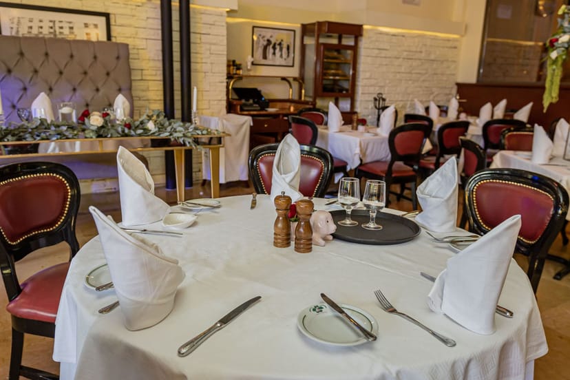 Private dining room with formal place settings for corporate events and intimate group parties.