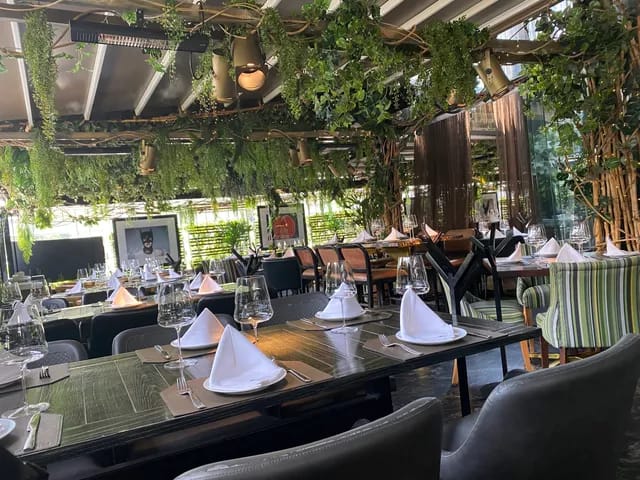 Private dining room at Au Pied de Cochon with lush biophilic design for corporate events.