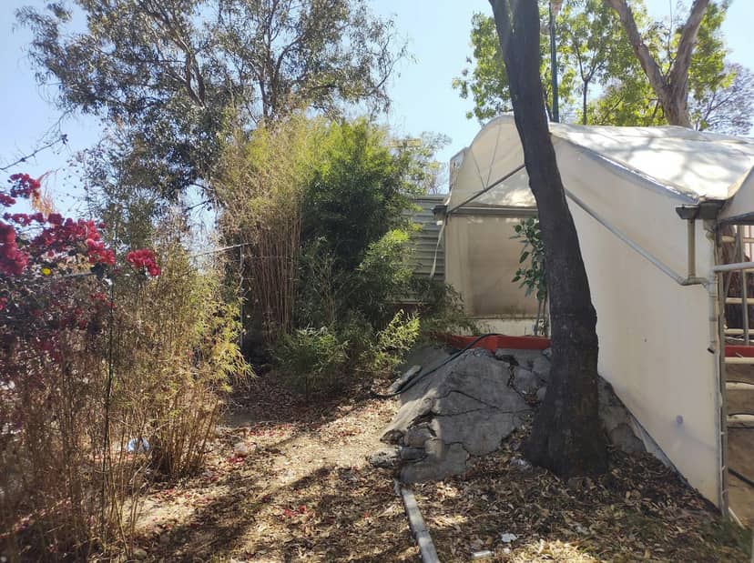 Unsafe community center outdoor event space with uneven terrain and poor site preparation.