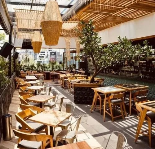 Modern BENIU semi-outdoor event space with biophilic design for networking and corporate receptions.