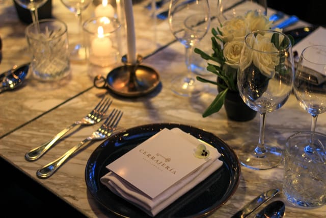 Upscale corporate dinner table setting with marble surfaces for boutique private events.