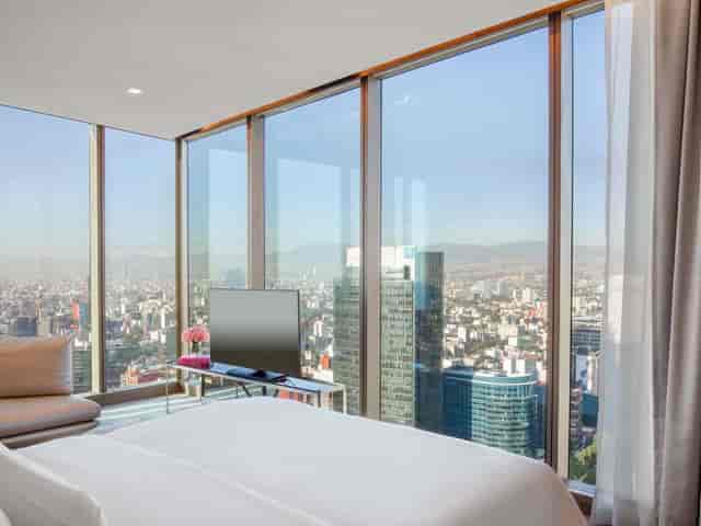 Executive suite at Accor Hotels with urban view for VIP speaker events and corporate workshops.